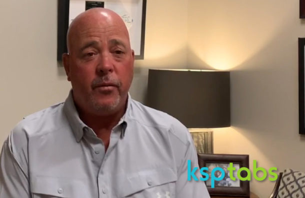 Man in a light gray shirt sitting indoors with 'ksptabs' logo in the corner.